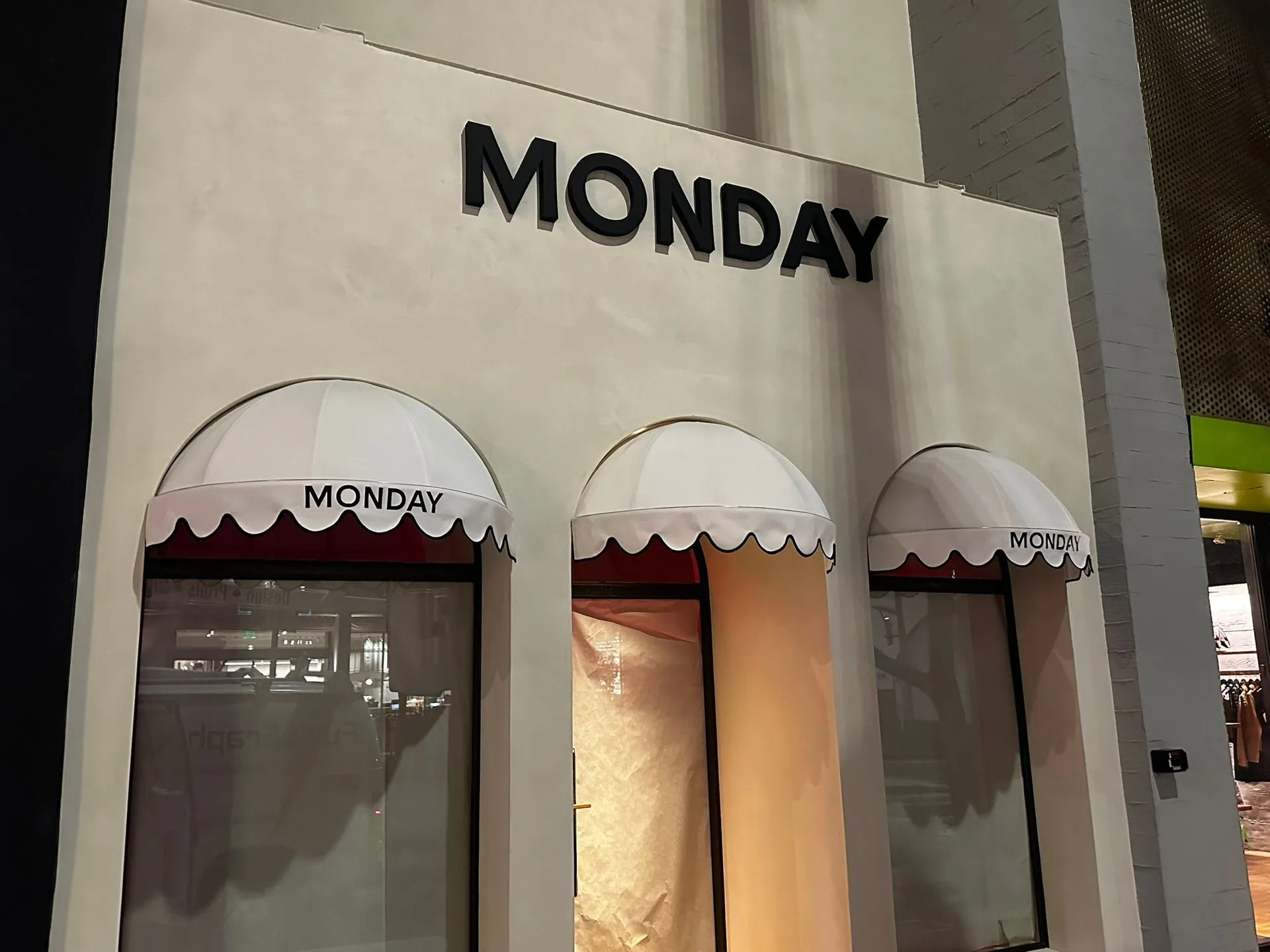 Custom business sign with LED illumination at dusk