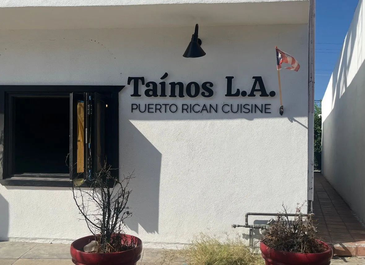 Storefront sign with halo-lit channel letters at night